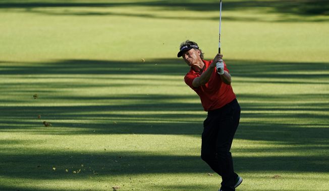 Bernhard Langer, of Germany, hits on the 15th hole during the second round of the Masters golf tournament Friday, Nov. 13, 2020, in Augusta, Ga. (AP Photo/David J. Phillip)