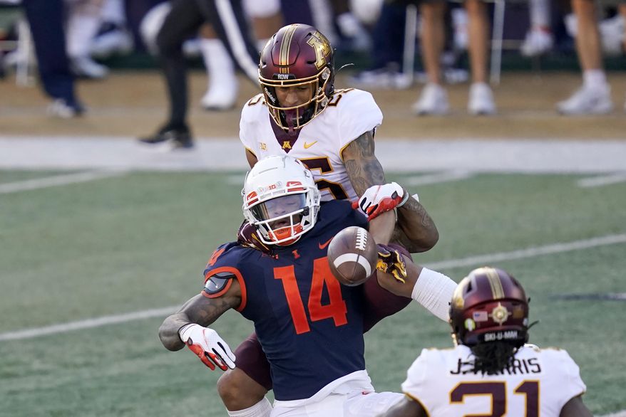 Minnesota defensive back Benjamin St-Juste breaks up a pass intended for Illinois punter Blake Hayes (14) during the first half of an NCAA college football game Saturday, Nov. 7, 2020, in Champaign , Ill. (AP Photo/Charles Rex Arbogast)