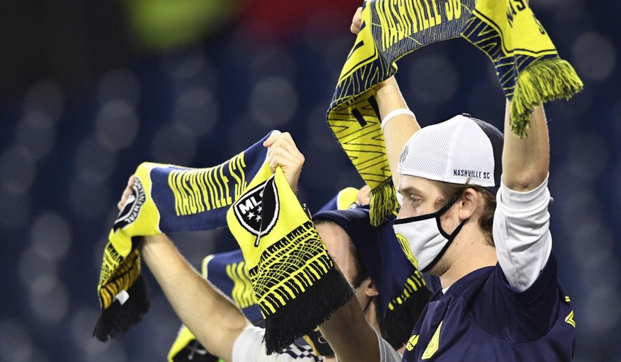 Nashville SC fans cheer on the team during an MLS soccer match against the Chicago Fire in Nashville, Tenn., Saturday, Oct. 31, 2020. (Larry McCormack/The Tennessean via AP)