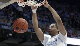 FILE - In this March 3, 2020, file photo, North Carolina&#39;s Garrison Brooks dunks against Wake Forest during the first half of an NCAA college basketball game in Chapel Hill, N.C. Brooks is a 6-foot-10 senior and was the preseason Atlantic Coast Conference player of the year. (AP Photo/Chris Seward, File)