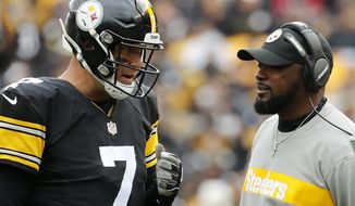 FILE - In this Oct. 28, 2018, file photo, Pittsburgh Steelers quarterback Ben Roethlisberger and coach Mike Tomlin during the team&#x27;s NFL football game against the Cleveland Browns in Pittsburgh. Roethlisberger, who went out in Game 2 last season with an elbow injury, received lots of support as a candidate for comeback player of the year, at the halfway point of the season. Tomlin was lauded for coach of the year, at this point of the season, by Hall of Famer James Lofton and hall voter Rick Gosselin. (AP Photo/Winslow Townson, File)