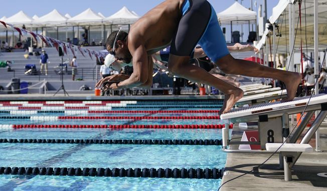 Ous Mellouli dives in for the men&#x27;s 400 meter freestyle at the U.S. Open swimming championships Friday, Nov. 13, 2020, in Irvine, Calif. (AP Photo/Ashley Landis)