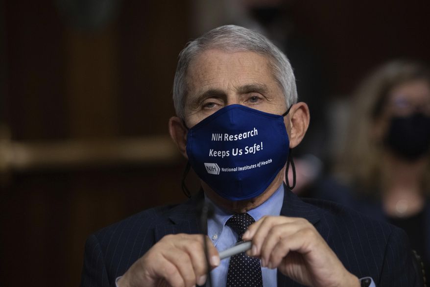 Dr. Anthony Fauci, Director of the National Institute of Allergy and Infectious Diseases at the National Institutes of Health, listens during a Senate Senate Health, Education, Labor, and Pensions Committee Hearing on the federal government response to COVID-19 Capitol Hill in Washington, Sept. 23, 2020. Fauci is recommending masks at Thanksgiving gatherings if the coronavirus status of people is unknown.  (Graeme Jennings/Pool via AP)
