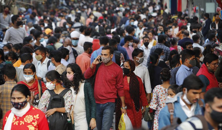 People throng a market to shop ahead of the Diwalli festival in New Delhi, India, Thursday, Nov. 12, 2020. Authorities in New Delhi have banned firecrackers and are appealing to people to celebrate the Hindu festival of lights at home. Coronavirus infections have been rising in the capital and authorities are worried large festival crowds will worsen the virus situation.(AP Photo/Manish Swarup)