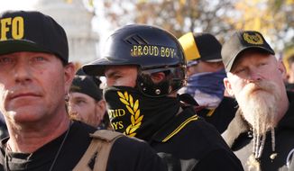 A person wearing attire with the words Proud Boys on it joins supporters of President Donald Trump in a march Saturday Nov. 14, 2020, in Washington. (AP Photo/Jacquelyn Martin)