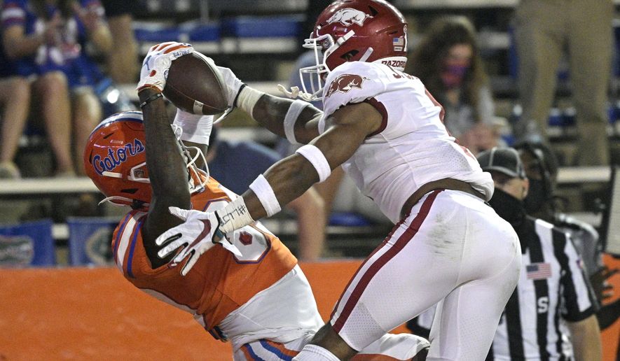 Florida wide receiver Justin Shorter, left, catches a pass in the end zone for a 21-yard touchdown in front of Arkansas defensive back Jalen Catalon during the first half of an NCAA college football game Saturday, Nov. 14, 2020, in Gainesville, Fla. (AP Photo/Phelan M. Ebenhack)