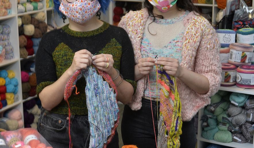 Twins Jes Velez, left, and Erica Velez, both 30, visit Habetrot's Wheel, the knitting-supply shop they frequent, on Saturday, Oct. 24, 2020, in Harborcreek Township, Pa.. The women enjoy knitting a variety of items including the sweaters they both wear. (Greg Wohlford/Erie Times-News via AP)