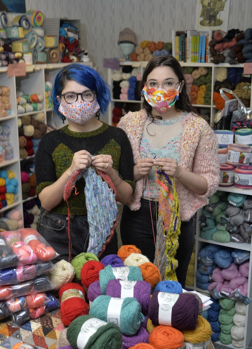 Twins Jes Velez, left, and Erica Velez, both 30, visit Habetrot's Wheel, the knitting-supply shop they frequent, on Saturday, Oct. 24, 2020, in Harborcreek Township, Pa.. The women enjoy knitting a variety of items including the sweaters they both wear. (Greg Wohlford/Erie Times-News via AP)
