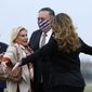 U.S. Secretary of State Mike Pompeo, center, and his wife Susan, right, embrace U.S. Ambassador to France Jamie McCourt, left, after stepping off a plane at Paris Le Bourget Airport, Saturday, Nov. 14, 2020, in Le Bourget, France. Pompeo is beginning a 10-day trip to Europe and the Middle East. (AP Photo/Patrick Semansky, Pool)