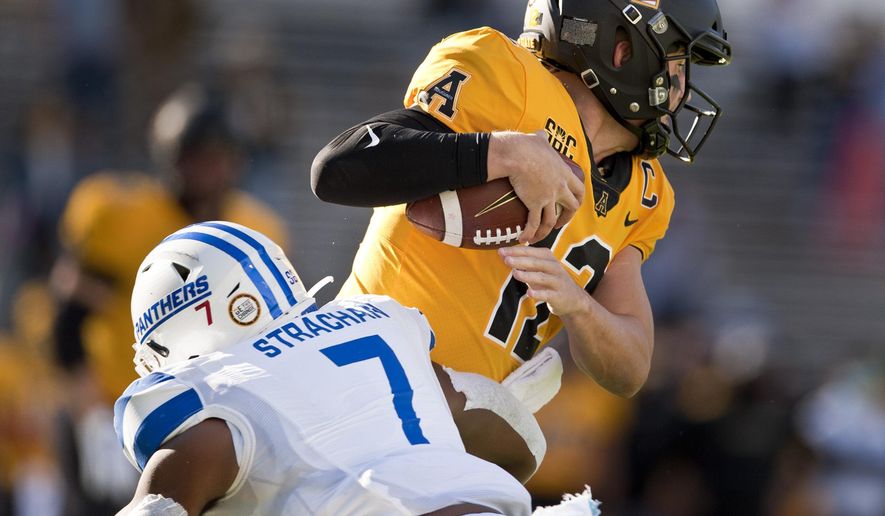 Appalachian State quarterback Zac Thomas is sacked by Georgia State's Jordan Strachan in the first half of an NCAA football game, Saturday, Nov. 14, 2020, in Boone, N.C. (Walt Unks/Winston-Salem Journal via AP)