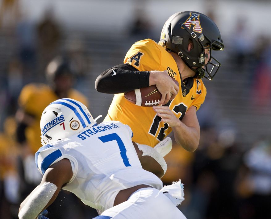 Appalachian State quarterback Zac Thomas is sacked by Georgia State's Jordan Strachan in the first half of an NCAA football game, Saturday, Nov. 14, 2020, in Boone, N.C. (Walt Unks/Winston-Salem Journal via AP)