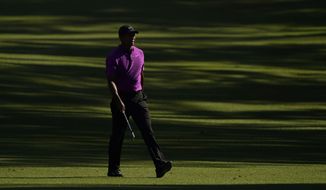 Tiger Woods walks on the 13th fairway during the third round of the Masters golf tournament Saturday, Nov. 14, 2020, in Augusta, Ga. (AP Photo/David J. Phillip)