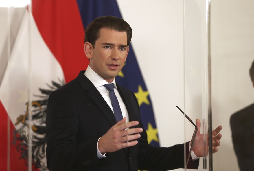 Austrian Chancellor Sebastian Kurz makes an address behind a plexiglass shield, at the federal chancellery in Vienna, Austria, Saturday, Nov. 14, 2020. The Austrian government has moved to restrict freedom of movement for people, in an effort to slow the onset of the COVID-19 coronavirus. (AP Photo/Ronald Zak)