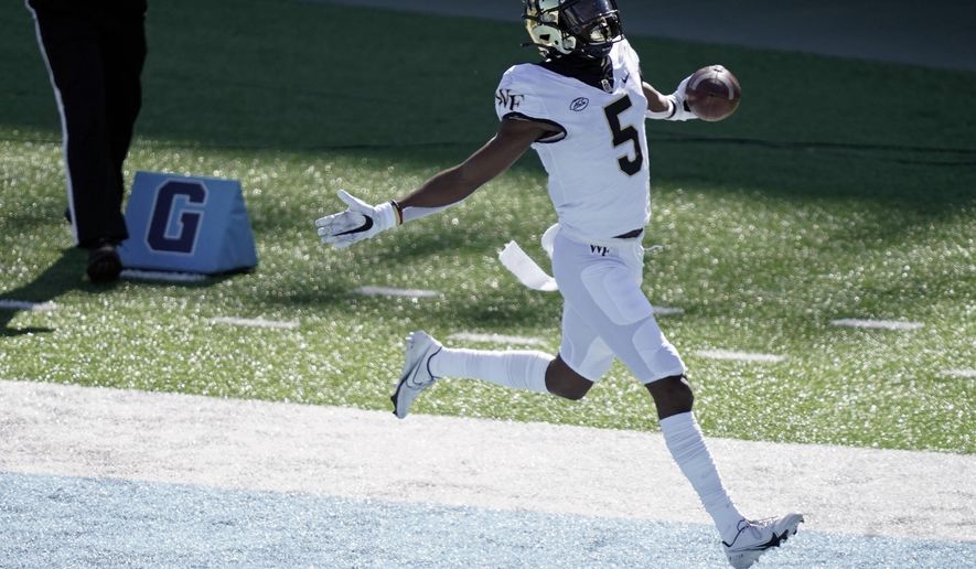 Wake Forest wide receiver Jaquarii Roberson (5) scores a touchdown against North Carolina during the first half of an NCAA college football game in Chapel Hill, N.C., Saturday, Nov. 14, 2020. (AP Photo/Gerry Broome)