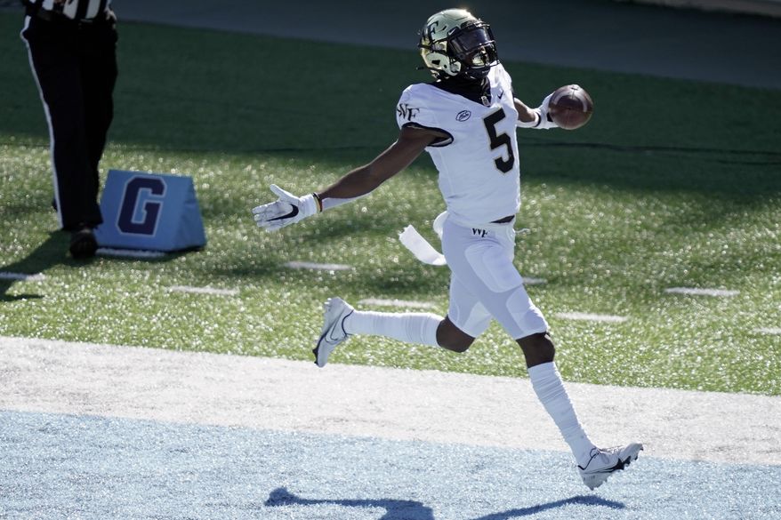 Wake Forest wide receiver Jaquarii Roberson (5) scores a touchdown against North Carolina during the first half of an NCAA college football game in Chapel Hill, N.C., Saturday, Nov. 14, 2020. (AP Photo/Gerry Broome)