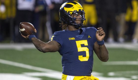 Michigan quarterback Joe Milton throws a pass during the first quarter of the team&#39;s NCAA college football game against Wisconsin in Ann Arbor, Mich., Saturday, Nov. 14, 2020. (AP Photo/Tony Ding)