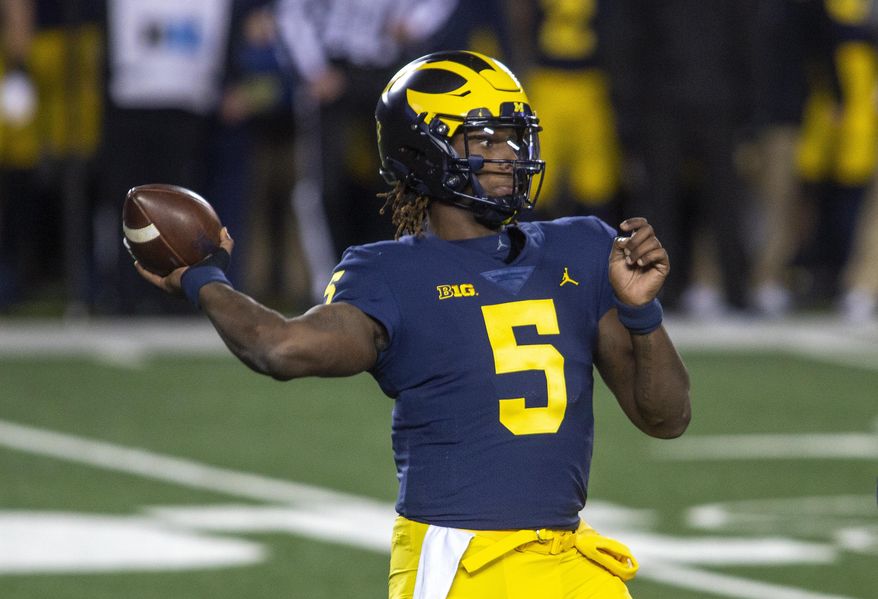 Michigan quarterback Joe Milton throws a pass during the first quarter of the team&#x27;s NCAA college football game against Wisconsin in Ann Arbor, Mich., Saturday, Nov. 14, 2020. (AP Photo/Tony Ding)