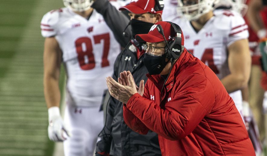 Wisconsin coach Paul Chryst cheers on his players from the sideline during the first quarter of the team's NCAA college football game against Michigan in Ann Arbor, Mich., Saturday, Nov. 14, 2020. (AP Photo/Tony Ding)