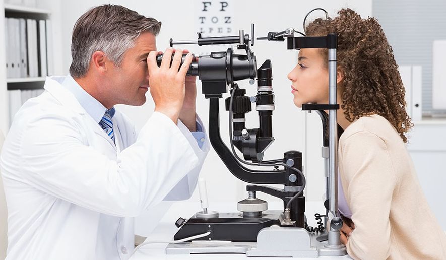 Eye doctor with patient (sponsored)