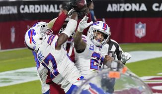 Arizona Cardinals wide receiver DeAndre Hopkins catches the game-winning touchdown as Buffalo Bills cornerback Tre&#39;Davious White (27), free safety Jordan Poyer (21) and strong safety Micah Hyde, left, defend during the second half of an NFL football game, Sunday, Nov. 15, 2020, in Glendale, Ariz. The Cardinals won 32-20. (AP Photo/Ross D. Franklin)