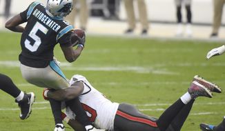 Carolina Panthers quarterback Teddy Bridgewater, left, is sacked by Tampa Bay Buccaneers outside linebacker Jason Pierre-Paul, right, during fourth-quarter NFL football game action in Charlotte, N.C., Sunday, Nov. 15, 2020. (Jeff Siner/The Charlotte Observer via AP)