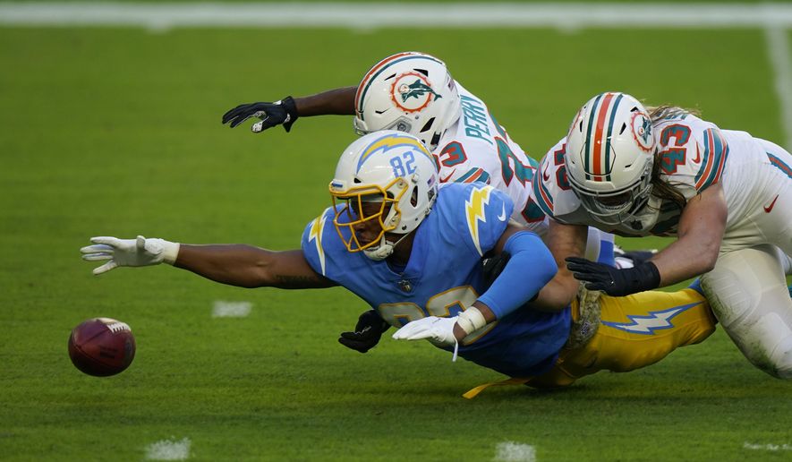Los Angeles Chargers tight end Stephen Anderson (82), Miami Dolphins cornerback Jamal Perry (33) and outside linebacker Andrew Van Ginkel (43) go after the football after a punt was blocked, during the first half of an NFL football game, Sunday, Nov. 15, 2020, in Miami Gardens, Fla. (AP Photo/Wilfredo Lee)