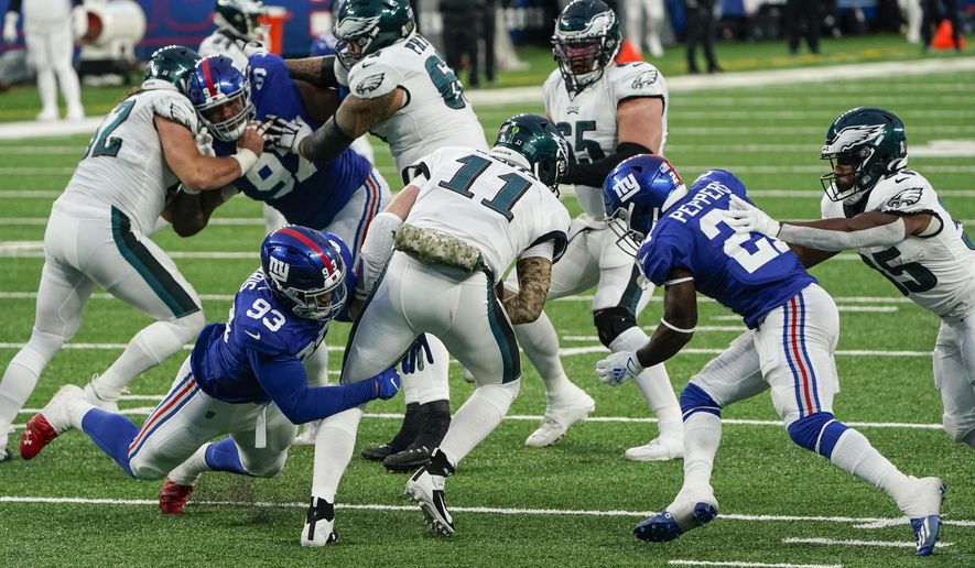 New York Giants' Trent Harris (93) and Jabrill Peppers (21) sack Philadelphia Eagles' Carson Wentz (11) during the second half of an NFL football game Sunday, Nov. 15, 2020, in East Rutherford, N.J. (AP Photo/Seth Wenig)