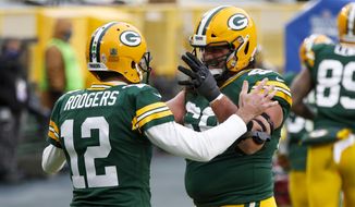 Green Bay Packers&#39; Aaron Rodgers celebrates his touchdown run with David Bakhtiari during the first half of an NFL football game against the Jacksonville Jaguars Sunday, Nov. 15, 2020, in Green Bay, Wis. (AP Photo/Matt Ludtke)