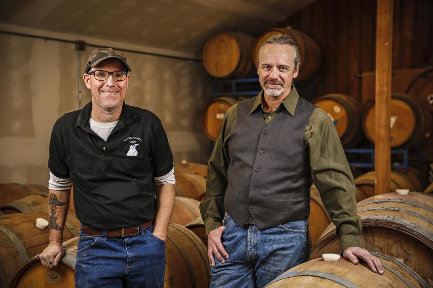 Will Neiman and Dan Murphy of White Raven Winery pose in Columbia Falls, Montana on Nov. 4, 2020. Neiman and Murphy are using Montana-grown grapes to make wines. (Hunter D'Antuono /Flathead Beacon via AP)