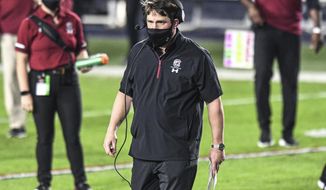 South Carolina coach Will Muschamp heads to check on an injured player during the first half of the team&#39;s NCAA college football game against Mississippi in Oxford, Miss., Saturday, Nov. 14, 2020. (AP Photo/Bruce Newman)