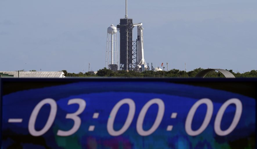 The countdown clock is stopped at a three-hour built in hold as a SpaceX Falcon 9 rocket, with the company&#39;s Crew Dragon capsule attached, sits on the launch pad at Launch Complex 39A Sunday, Nov. 15, 2020, at the Kennedy Space Center in Cape Canaveral, Fla. Four astronauts will fly on the SpaceX Crew-1 mission to the International Space Station scheduled for launch on later today. (AP Photo/Chris O&#39;Meara)