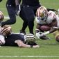 New Orleans Saints quarterback Taysom Hill fumbles as San Francisco 49ers safety Marcell Harris (36) recovers the ball in the second half of an NFL football game in New Orleans, Sunday, Nov. 15, 2020. (AP Photo/Butch Dill)