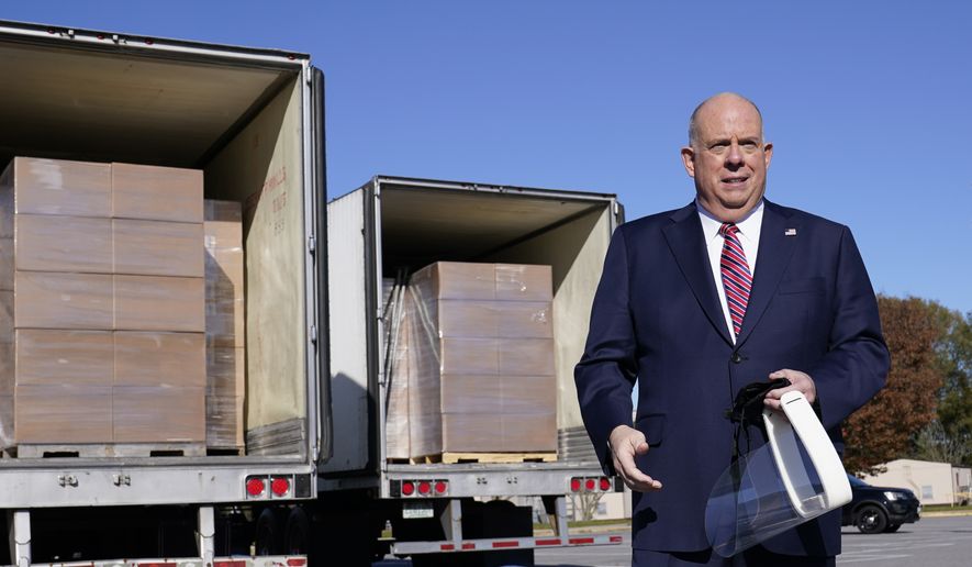 Maryland Gov. Larry Hogan holds a face shield as he speaks during a news conference in Annapolis, Md., Monday, Nov. 16, 2020, in front of several truckloads of face shields. Hardwire LLC donated 200,000 face shields to provide protection for Maryland teachers and students during the coronavirus pandemic. (AP Photo/Susan Walsh) **FILE**