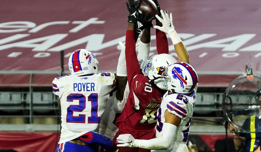 Arizona Cardinals wide receiver DeAndre Hopkins (10) pulls in the game winning touchdown pass as Buffalo Bills free safety Jordan Poyer (21) and strong safety Micah Hyde (23) defend during the second half of an NFL football game, Sunday, Nov. 15, 2020, in Glendale, Ariz. The Cardinals won 32-20. (AP Photo/Rick Scuteri)
