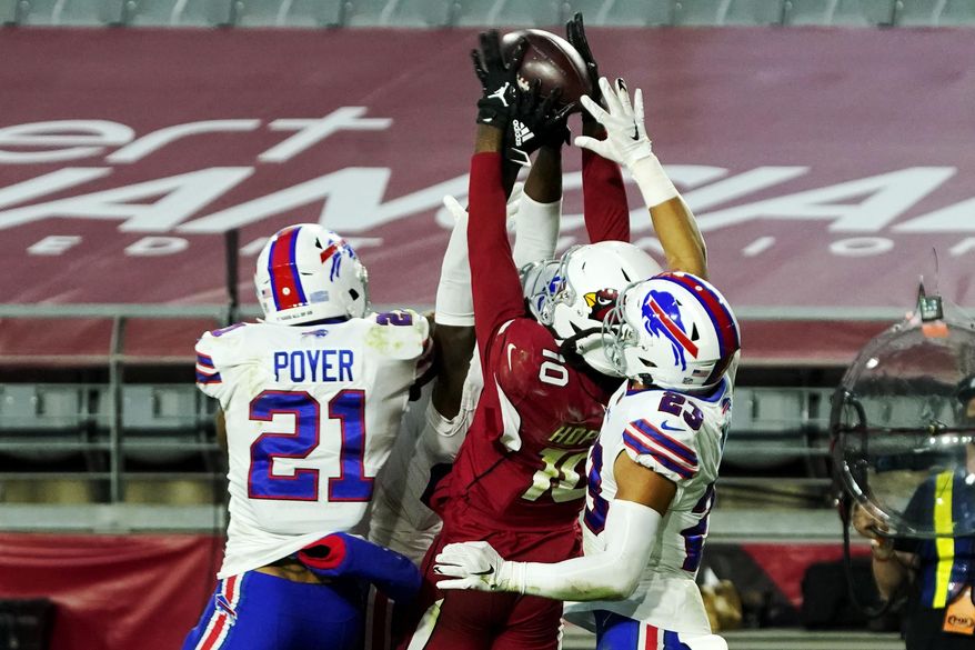 Arizona Cardinals wide receiver DeAndre Hopkins (10) pulls in the game winning touchdown pass as Buffalo Bills free safety Jordan Poyer (21) and strong safety Micah Hyde (23) defend during the second half of an NFL football game, Sunday, Nov. 15, 2020, in Glendale, Ariz. The Cardinals won 32-20. (AP Photo/Rick Scuteri)
