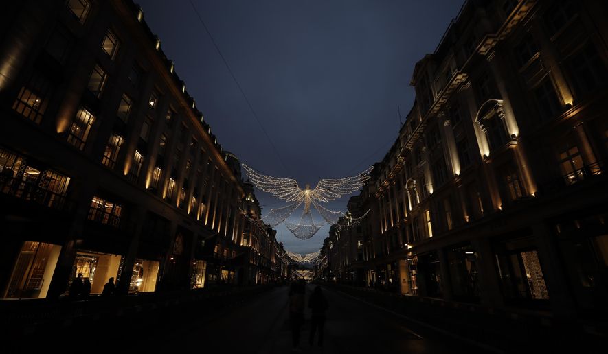 The Regent Street Christmas lights entitled &#39;The Spirit of Christmas&#39; stand illuminated after being switched on yesterday without a ceremony as shops on the street lie temporarily closed due to England&#39;s second coronavirus lockdown, in London, Sunday, Nov. 15, 2020. This week saw Britain on Wednesday become the fifth country in the world to record more than 50,000 coronavirus-related deaths and on Thursday to record 33,470 people testing positive for COVID-19, the highest daily number of new cases since the virus first struck. (AP Photo/Matt Dunham)