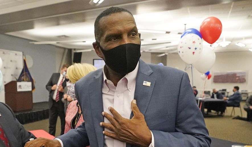 Burgess Owens, a Republican candidate in Utah&#39;s 4th Congressional District, speaks with people during a Utah Republican election night party Tuesday, Nov. 3, 2020, in Sandy, Utah. (AP Photo/Rick Bowmer)