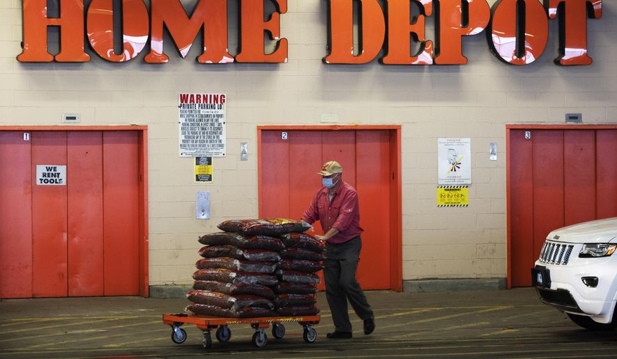 FILE - In this April 3, 2020 file photo, a Home Depot customer pushes a cart loaded with supplies in New York. Home Depot is buying HD Supply Co.,  a distributor of maintenance, repair and operations products in the multifamily and hospitality end markets, in a deal valued at about $8 billion. The transaction is expected to close during Home Depot&#39;s fiscal fourth quarter. (AP Photo/Mark Lennihan, File)
