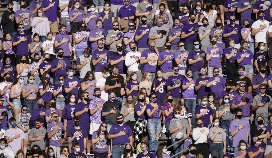 Kansas State fans and students stand for the national anthem before an NCAA college football game against Oklahoma State in Manhattan, Kan., Saturday, Nov. 7, 2020. (AP Photo/Orlin Wagner)