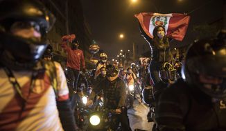 A caravan of demonstrators on motorcycles ride as they wait for news on who will be the country&#39;s next president, in Lima, Peru, Sunday, Nov. 15, 2020. Manuel Merino announced his resignation following massive protests, unleashed when lawmakers ousted President Martin Vizcarra. (AP Photo/Rodrigo Abd)