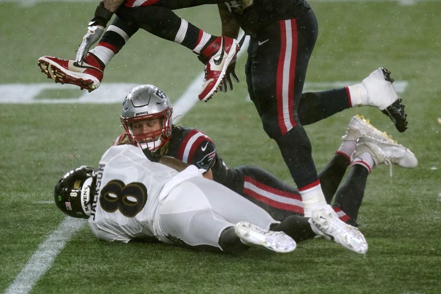 Baltimore Ravens quarterback Lamar Jackson (8) recovers an errant snap from center in the second half of an NFL football game against the New England Patriots, Sunday, Nov. 15, 2020, in Foxborough, Mass. (AP Photo/Elise Amendola)