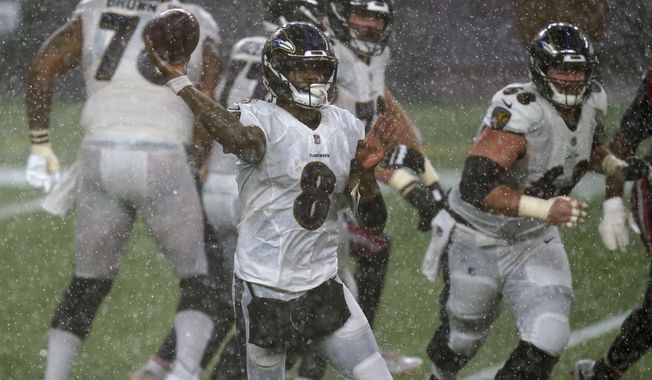 Baltimore Ravens quarterback Lamar Jackson passes during torrential rain in the second half of an NFL football game against the New England Patriots, Sunday, Nov. 15, 2020, in Foxborough, Mass. (AP Photo/Elise Amendola)