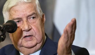 In this Aug. 30, 2018, file photo, Syrian Foreign Minister Walid al-Moallem gestures as he speaks to the media in Moscow, Russia. Al-Moallem, a career diplomat who became one of the country&#39;s most prominent faces to the outside world during the uprising against Syria&#39;s President Bashar Assad, died Monday, Nov. 16, 2020. He was 79. (AP Photo/Alexander Zemlianichenko, File)