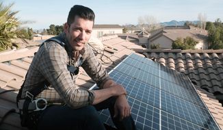 This image released by Independent Lens shows Jonathan Scott from &amp;quot;Property Brothers&amp;quot; installing solar panels on a rooftop in his new documentary “Jonathan Scott’s Power Trip.” The film premieres Monday night as part of “Independent Lens” on PBS stations across the country. (Neil Berkeley/Independent Lens via AP)