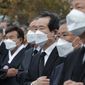 South Korean Prime Minister Chung Sye-kyun, third from right, wearing a face mask to help curb the spread of the coronavirus salutes during a ceremony to mark the 81st anniversary of the Memorial Day for Martyred Ancestors in Seoul, South Korea, Tuesday, Nov. 17, 2020. (AP Photo/Ahn Young-joon)