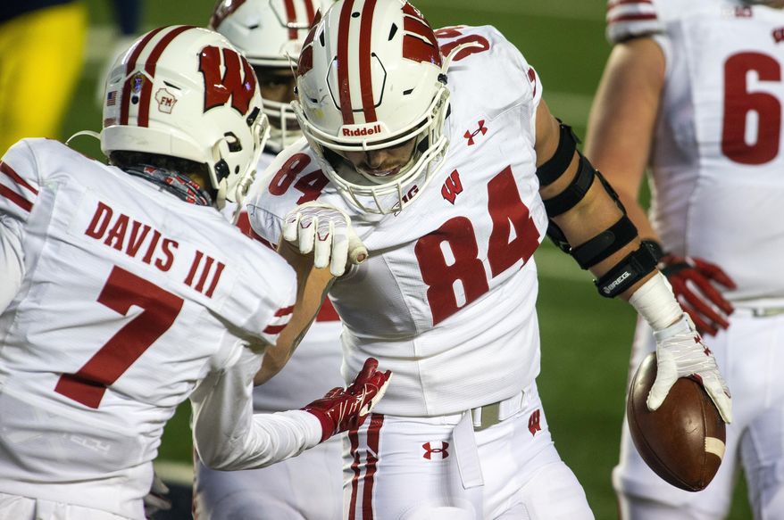 Wisconsin tight end Jake Ferguson (84) celebrates his touchdown with wide receiver Danny Davis III (7) in the third quarter of the team's NCAA college football game against Michigan in Ann Arbor, Mich., Saturday, Nov. 14, 2020. Wisconsin won 49-11. (AP Photo/Tony Ding)