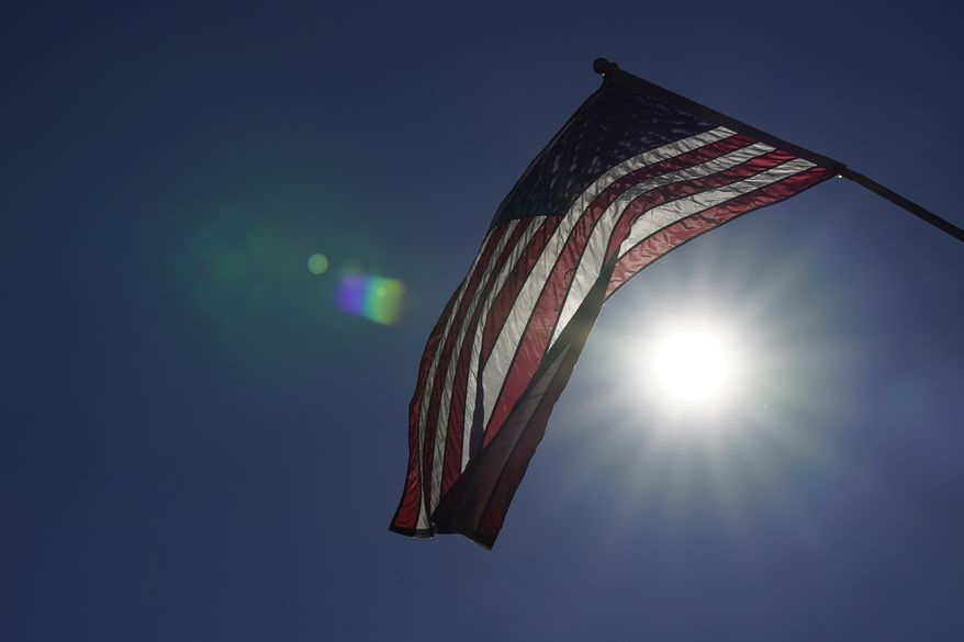 An American flag flies from a light pole, Wednesday, Nov. 11, 2020, in Terre Haute, Ind. Indiana's Vigo County had been America’s more reliable presidential bellwether, voting in line with the rest of the nation since 1956. But that winning streak ended this year, as it did for nearly all the country’s bellwethers, most of them blue-collar, overwhelmingly white communities in the Rust Belt. (AP Photo/Darron Cummings)