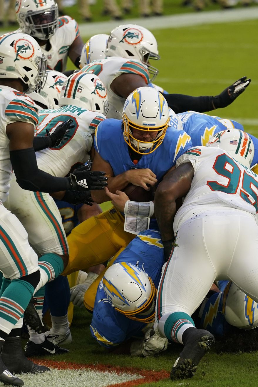 Los Angeles Chargers quarterback Justin Herbert (10) scores a touchdown during the first half of an NFL football game against the Miami Dolphins, Sunday, Nov. 15, 2020, in Miami Gardens, Fla. (AP Photo/Lynne Sladky)