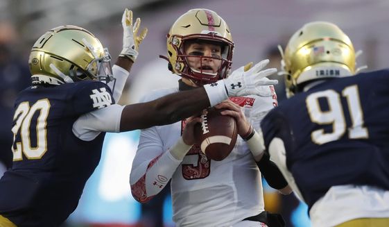 Notre Dame safety Shaun Crawford (20) sacks Boston College quarterback Phil Jurkovec (5) during the first half of an NCAA college football game, Saturday, Nov. 14, 2020, in Boston. (AP Photo/Michael Dwyer)