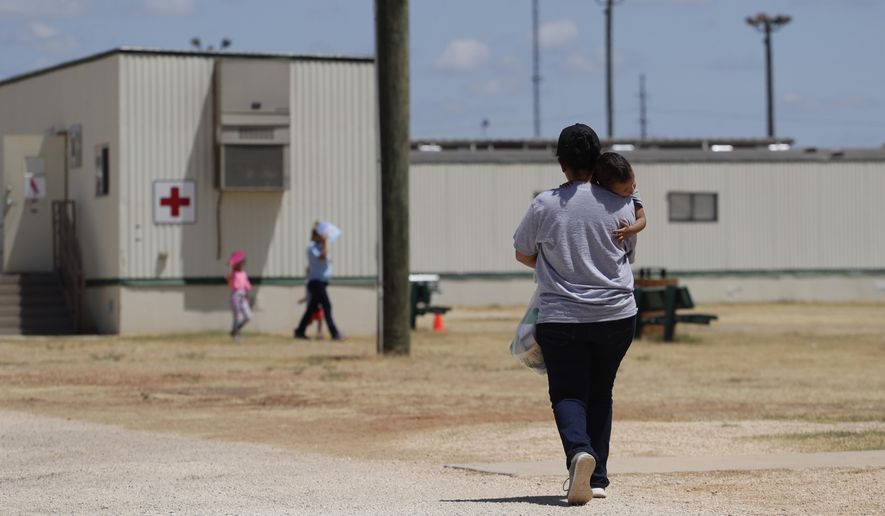 In this Aug. 23, 2019, photo, immigrants seeking asylum walk at the ICE South Texas Family Residential Center, in Dilley, Texas. A federal judge on Wednesday, Nov. 18, 2020, ordered the Trump administration to stop expelling immigrant children who cross the southern border alone, halting a policy that has resulted in thousands of rapid deportations of minors during the coronavirus pandemic. (AP Photo/Eric Gay) **FILE**
